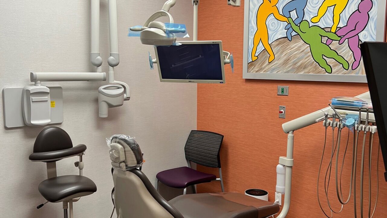 dental examination area with orange wall and artwork
