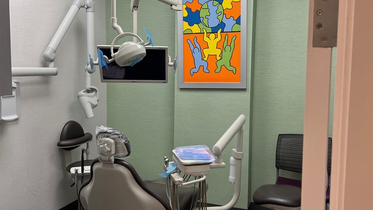 pediatric dental examination room with art on the wall