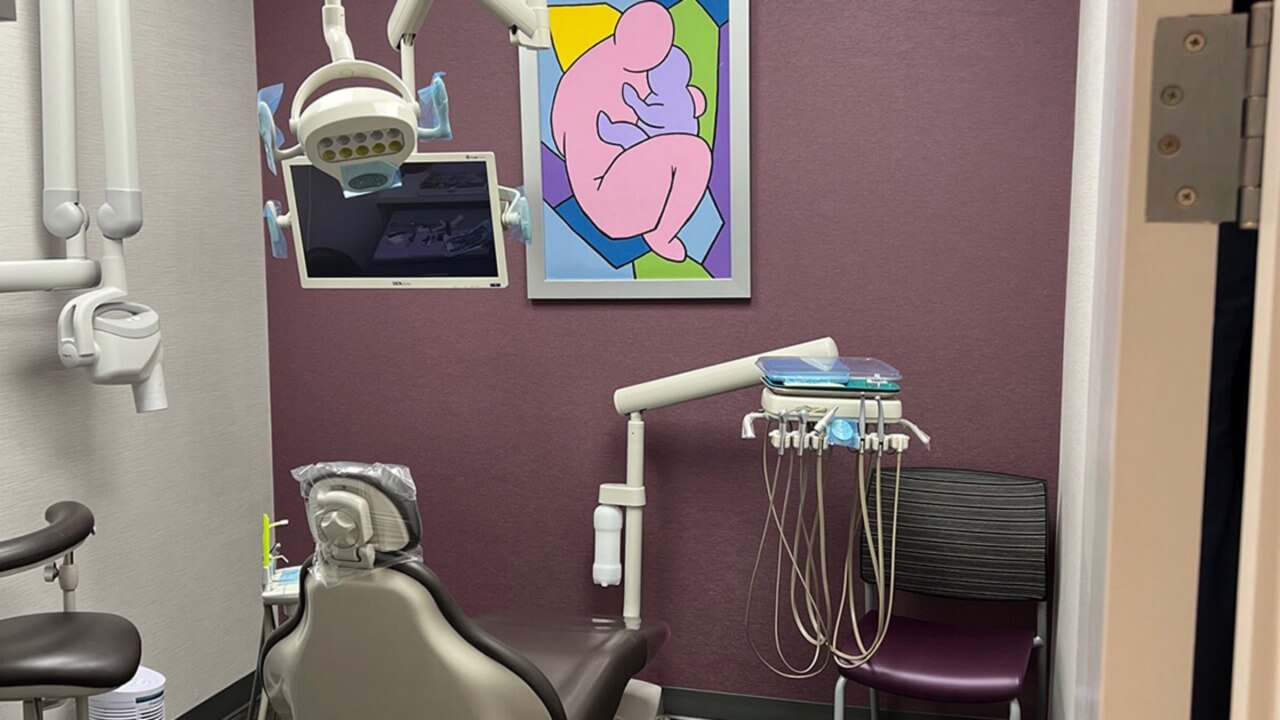 dental chair with flatscreen and wall art