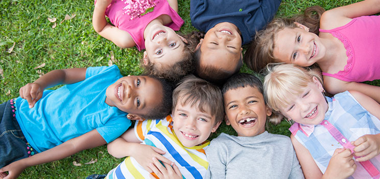 laughing children lay together in the grass