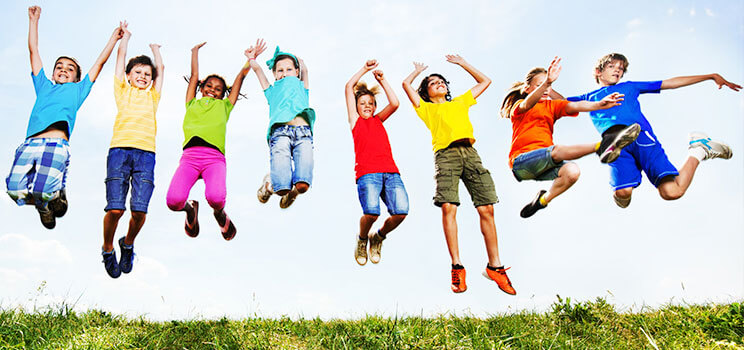 8 happy children leaping in the air